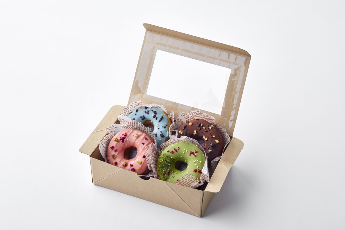 Gift box of colorful glazed cake donuts