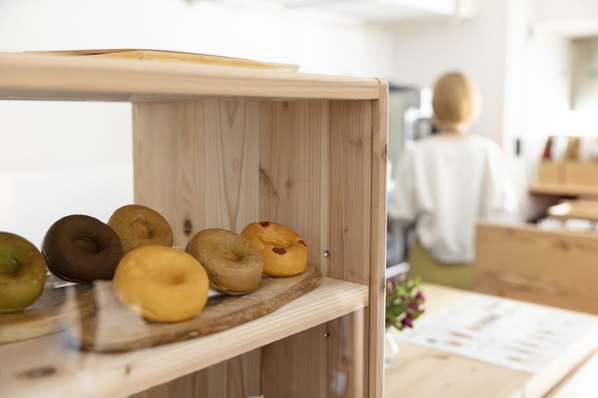 Wooden shelf displaying baked donuts