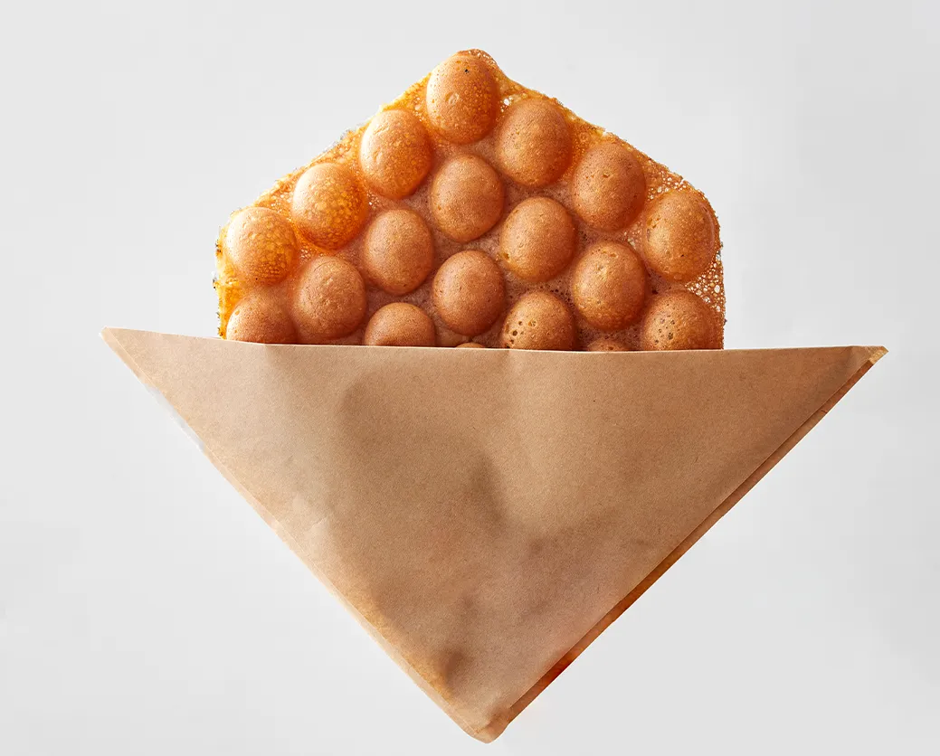 Rice flour bubble waffle in a kraft sleeve